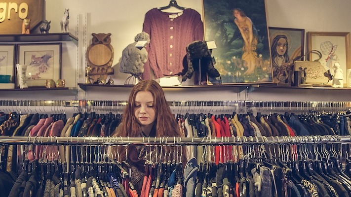 young person buying looking at clothes to purchase